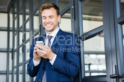 Businessman text messaging on smartphone