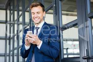 Businessman text messaging on smartphone