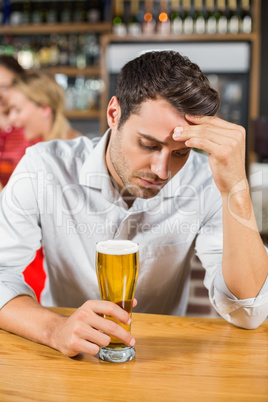 Tired man sitting in a bar