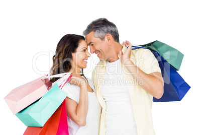 Attractive couple face to face holding shopping bags