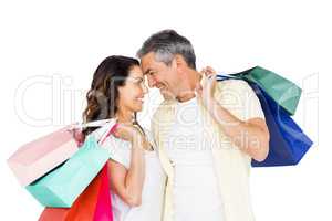 Attractive couple face to face holding shopping bags