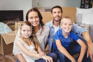 Portrait of smiling family with cardboard boxes