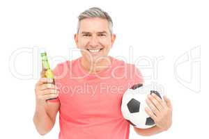 Happy man holding a soccer ball and a beer
