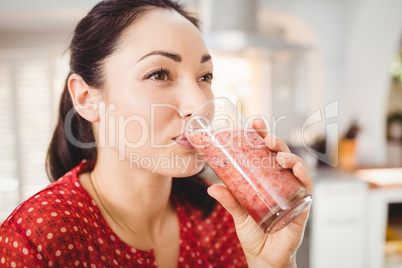 Close-up of woman drinking fruit juice