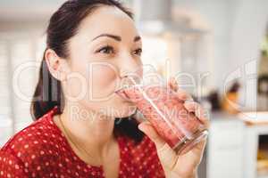 Close-up of woman drinking fruit juice