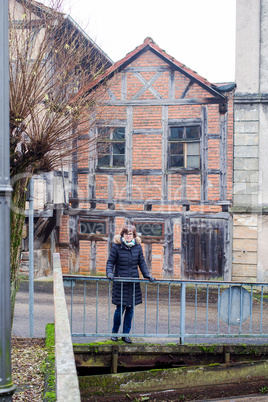woman in front of half-timbered house in Franconia