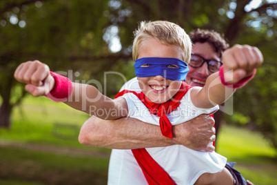 Father and son dressed as superman