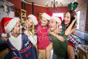 Men wearing Christmas wearing giving women piggyback rides