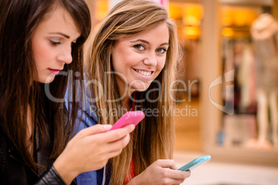 Two beautiful women using their phone Two beautiful women using their phone