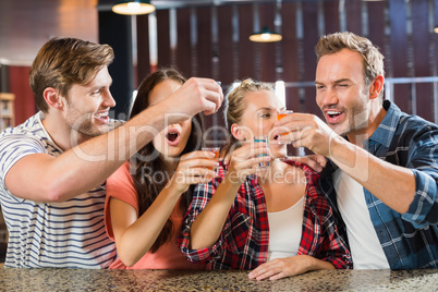 Friends toasting with shots