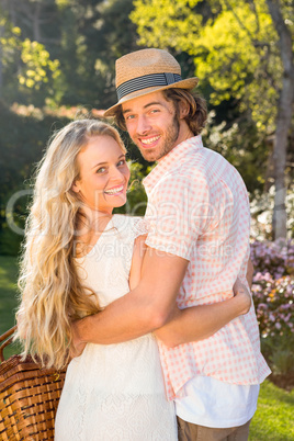 Rear view of a couple holding a picnic basket