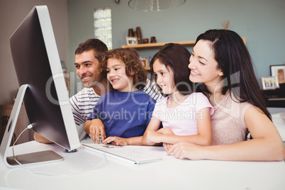 Close-up of happy family looking in computer