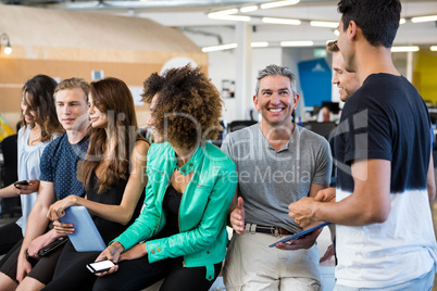 Group of businesspeople interacting during break time