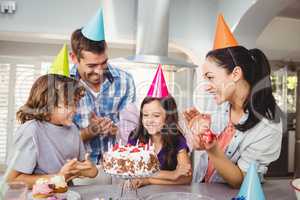 Happy family clapping during birthday celebration