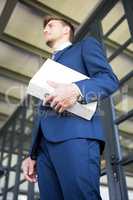 Businessman holding file with documents