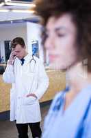 Tensed doctor standing in hospital