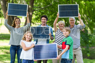 Family holding blackboard together