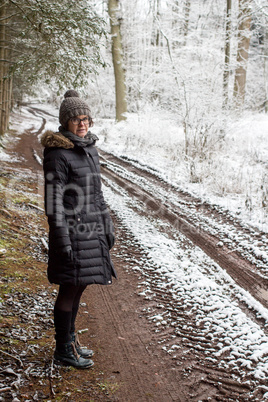 Woman taking a walk in snowy winter landscapes