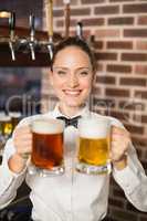 Female bartender holding beers