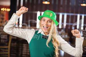 Woman with St. Patricks day hat and arms up
