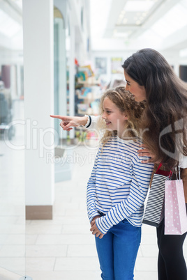 Happy mother and daughter in shopping mall