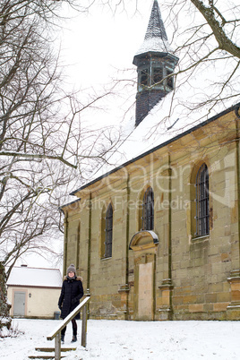 Woman before the winter church