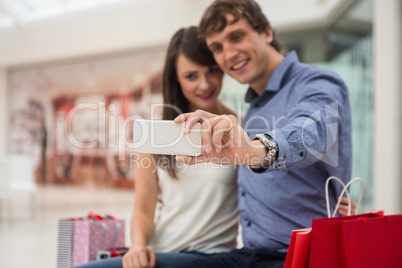 Couple taking a selfie in shopping mall