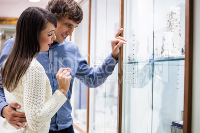 Happy couple shopping in jeweler shop