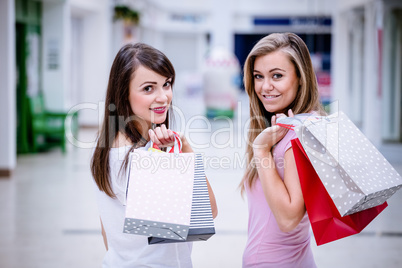 Portrait of two beautiful women shopping in mall