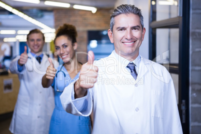 Medical team putting their thumbs up and smiling