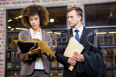 Lawyer and businesswoman looking at documents