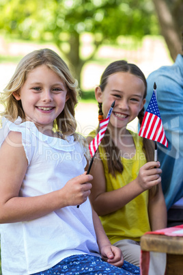 Family with American flag having a picnic