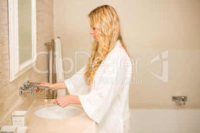 Blonde woman about to brush her teeth