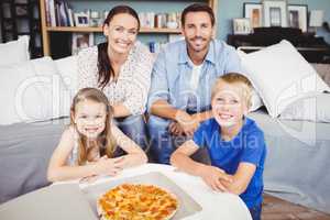Portrait of smiling family with pizza
