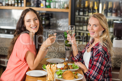 Women holding glasses of white wine