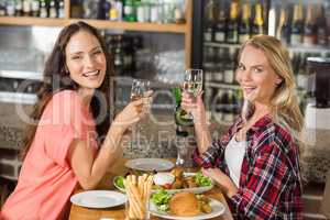 Women holding glasses of white wine