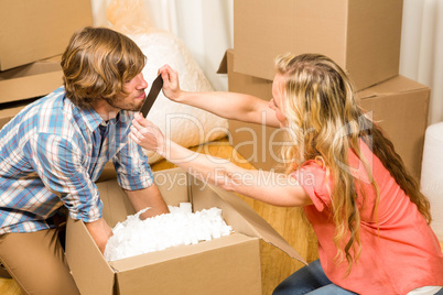 Happy couple unpacking after move