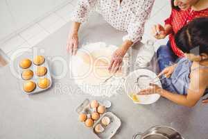 High angle view of girl helping family in preparing food