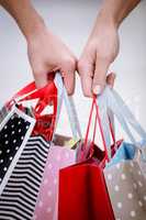 Close-up of two women carrying shopping bags