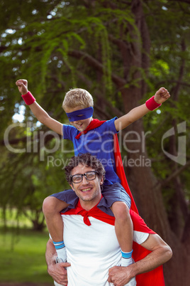 Father and son pretending to be superhero