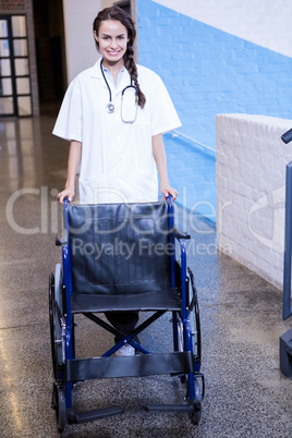 Female doctor standing with wheel chair