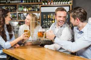 Friends toasting while looking at each other