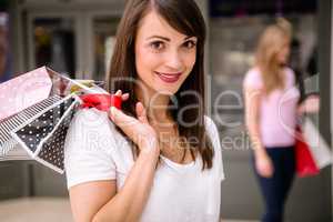 Portrait of woman holding shopping bags in mall
