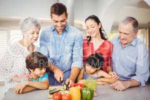 Happy man with family by kitchen table