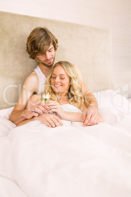 Cute couple cuddling in bed