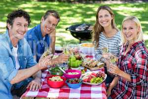 Friends having a picnic with wine