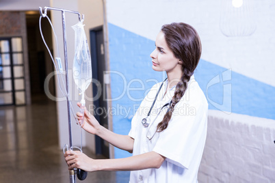 Female doctor checking a saline drip