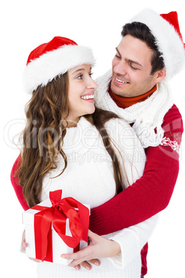 Festive couple holding christmas gift