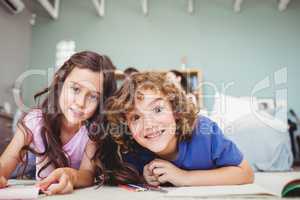 Portrait of children smiling while studying at home