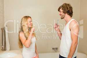 Cute couple brushing their teeth together